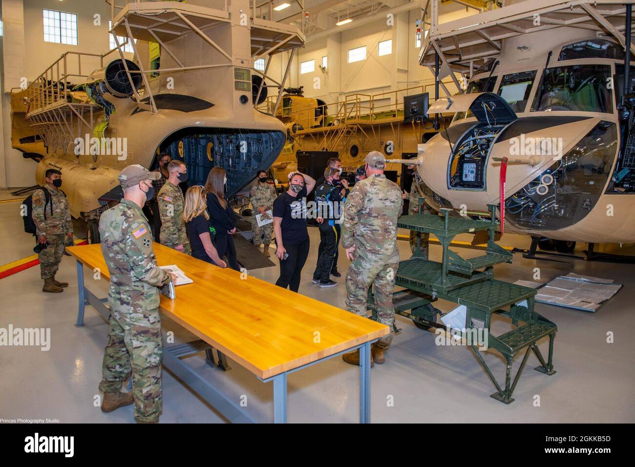 U. S. Army Soldiers assigned to 1st Battalion, 210th Aviation Regiment at Fort Eustis, Virginia, escort NASCAR driver Garrett Smithley and members of the Rick Ware Racing Team through the Company C, 1-210th Aviation hangar May 14, 2021. The team was shown UH-60 Black Hawk and CH-47 Chinook helicopter trainers utilized by over 500 students annually as well as the unit's training capabilities by subject matter experts. Stock Photo
