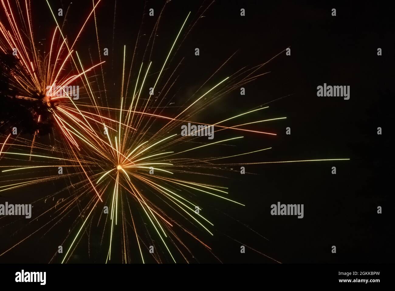 red and green sparks from fireworks in night sky celebration Stock Photo