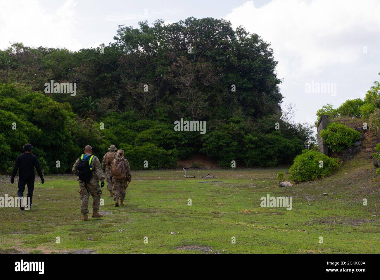 Airmen assigned to the 36th Security Forces Squadron perform a ground tasking operation overlooking a cliff face searching for signs of human activity along the eastern shoreline on Andersen Air Force Base, Guam May 14 2021. Andersen Air Force Base covers 14,600 acres, more than half of which is undeveloped land. Stock Photo