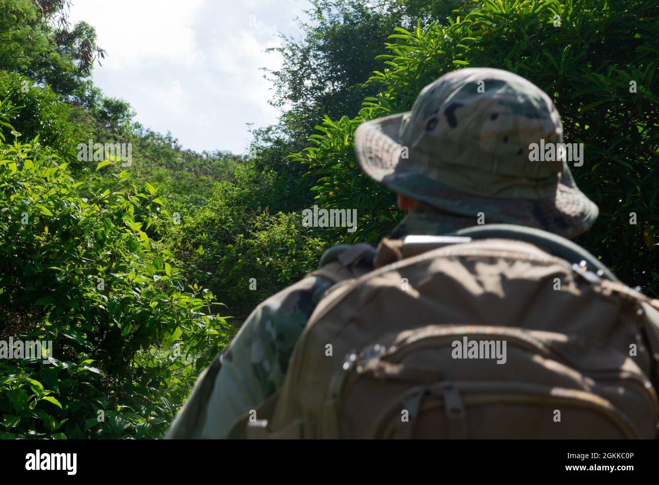 Tech. Sgt. Adam Rogers assigned to the 36th Security Forces Squadron performs a ground tasking operation through the uninhabited jungles on Andersen Air Force Base, Guam May 14 2021. Andersen Air Force Base covers 14,600 acres, more than half of which is undeveloped land. Stock Photo