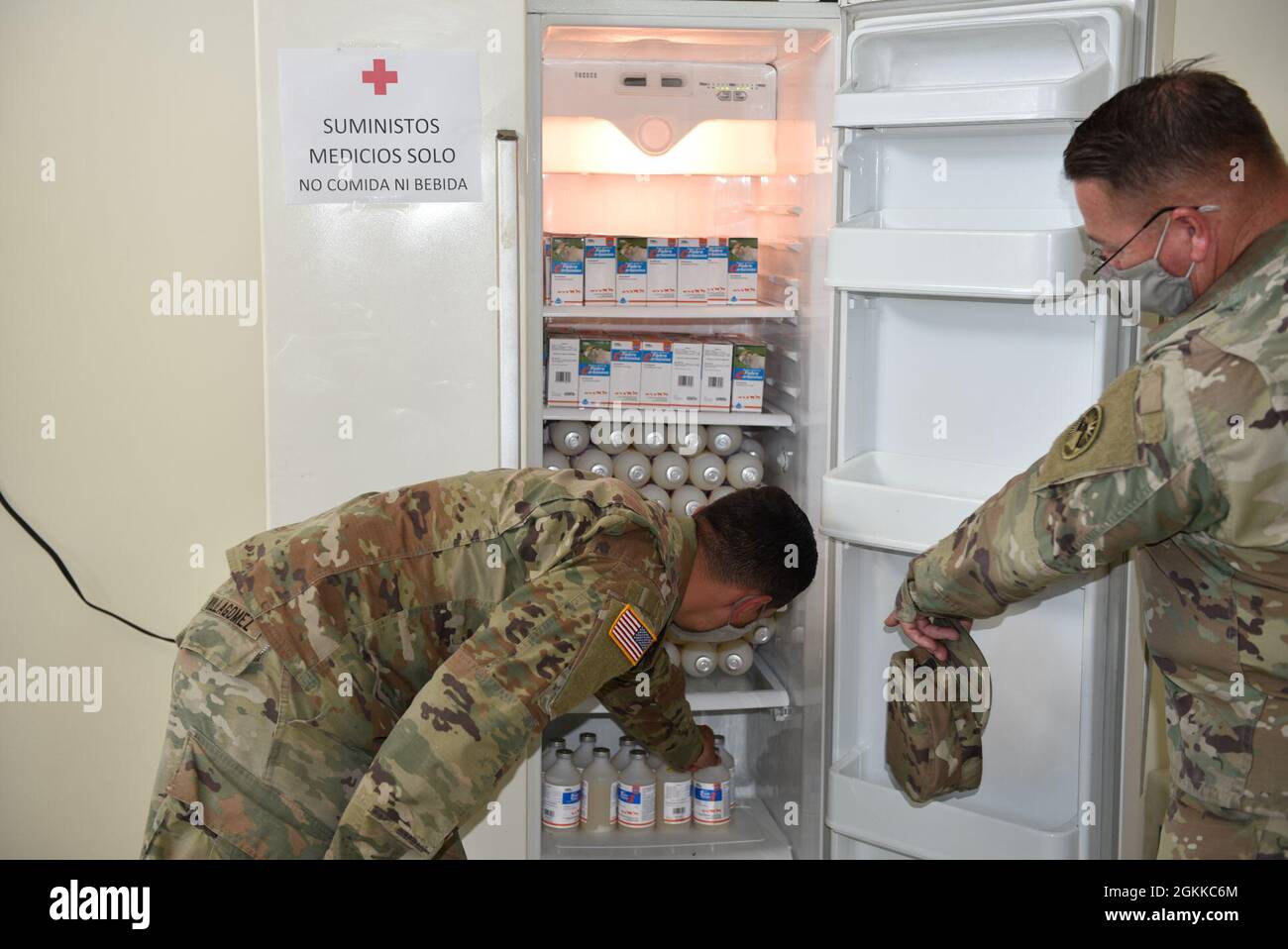 U.S. Army Capt. Johnny Villagomez, left, an engineer assigned to Joint Task Force-Bravo (JTF-B), Soto Cano Air Base, Honduras, and Sgt. Maj. John Gray, right, operations senior enlisted leader with JTF-B, store vaccinations for cattle in La Union, El Salvador, May 14, 2021. As part of Resolute Sentinel, veterinary specialists immunized cattle during a veterinary readiness training exercise in Tamarindo and El Jaguey, El Salvador. Stock Photo