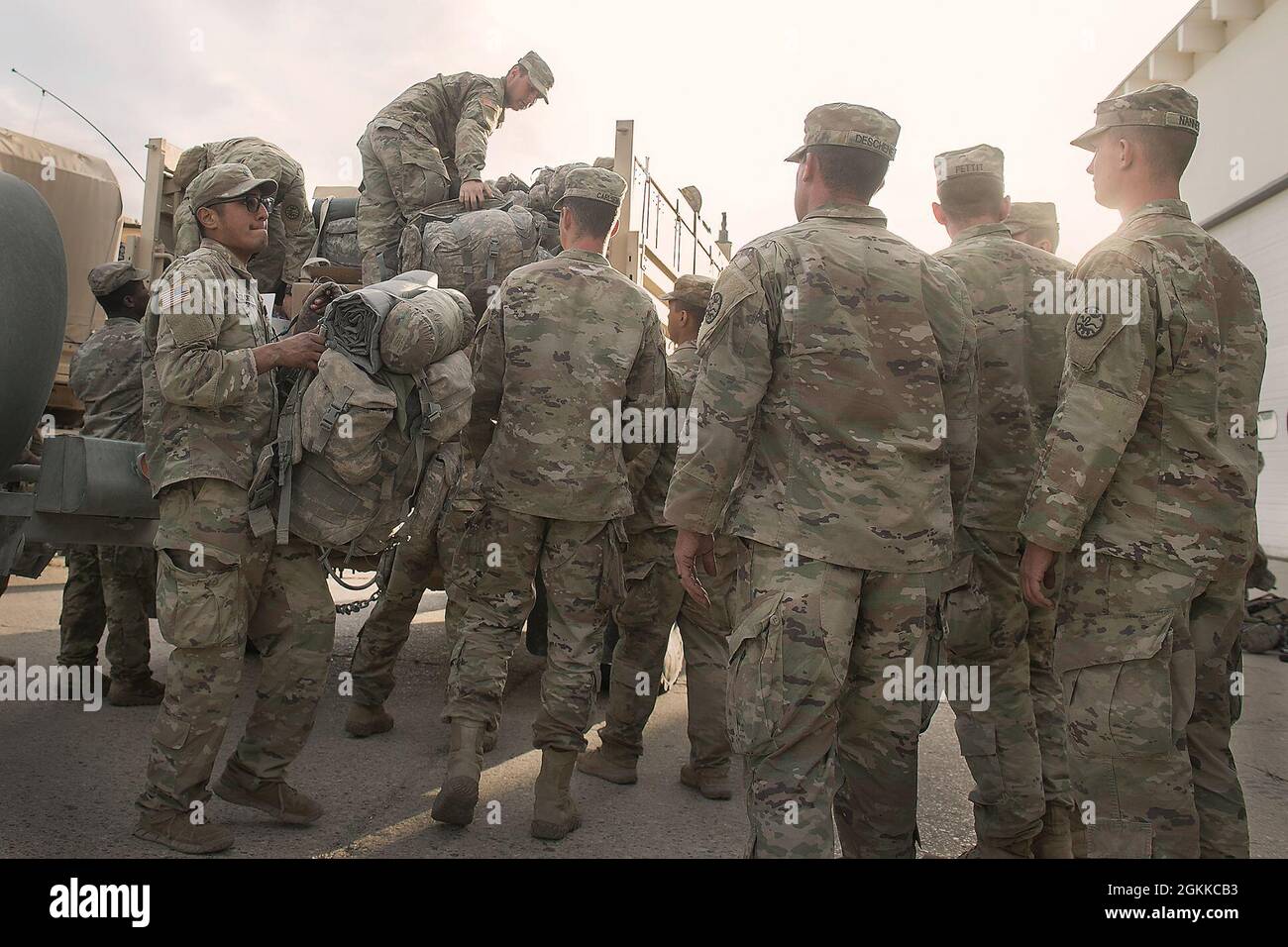 Soldiers from Charlie Company help unload equipment from company ...