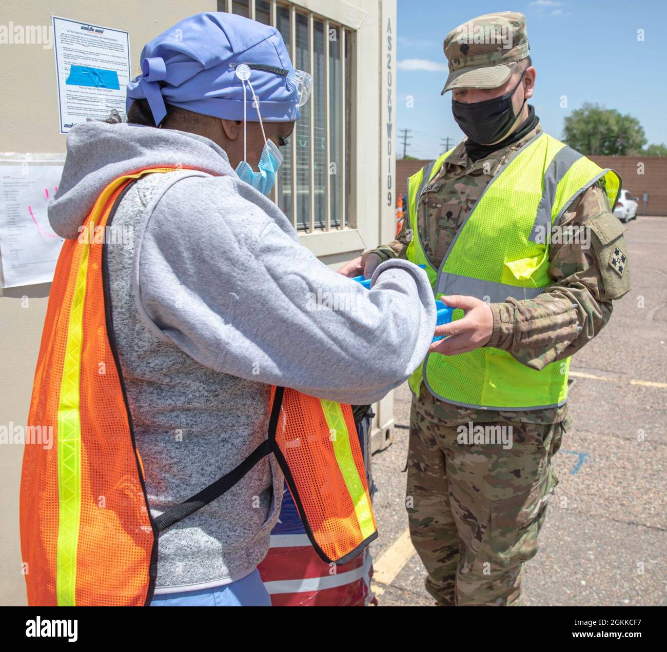 A civilian nurse, left, receives vaccines from U.S. Army Spc. Jacob Hospon, right, a combat medic assigned to 2nd Battalion, 12th Infantry Regiment, 2nd Stryker Brigade Combat Team, 4th Infantry Regiment, at the Community Vaccination Center at the Colorado State Fairgrounds in Pueblo, Colorado, May 15, 2021. The Soldiers deployed from Fort Carson, Colorado, to administer vaccinations to members of the Pueblo community and surrounding areas. U.S. Northern Command, through U.S. Army North, remains committed to providing continued, flexible Department of Defense support to the Federal Emergency M Stock Photo