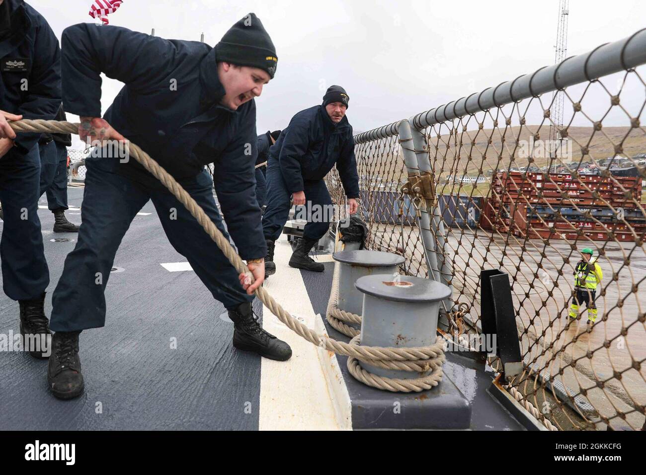 RUNAVIK, Faroe Islands (May 15, 2021) Yeoman 1st Class Chad Sawyer, right, passes directions to Operations Specialist 3rd Class Caleb Rhoads as he singles up a line aboard the Arleigh Burke-class guided-missile destroyer USS Ross (DDG 71) during a sea and anchor detail to pull the ship into port in the Faroe Islands, May 15, 2021. Ross, forward-deployed to Rota, Spain, is on patrol in the U.S. Sixth Fleet area of operations in support of regional allies and partners and U.S. national security interests in Europe and Africa. Stock Photo