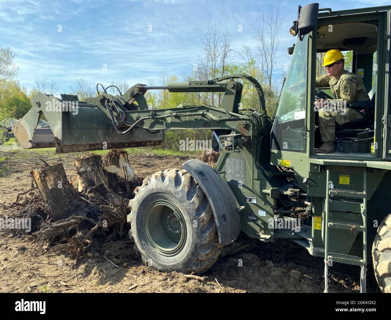 A New York Army National Guard Soldier assigned to the 152nd Engineer Company uses a dozer to clear tree trunks and debris during construction operations at the National Guard Youngstown Local Training Area in Youngstown, N.Y., May 15, 2021 during unit annual training. The company returned to the field for collective training for engineer tasks after a year of virtual training, constructing an Army Combat Fitness Course, a Situational Training Exercise lanes course and a land navigation course. Stock Photo
