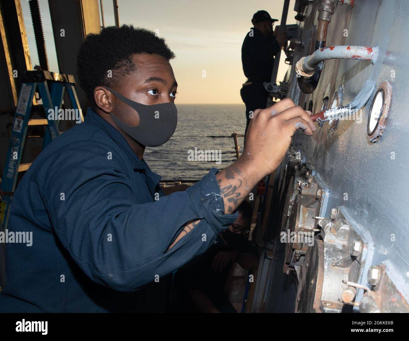 210515-N-IP743-1000 PHILIPPINE SEA (May 15, 2021) Gas Turbine Systems Technician (Mechanical) 3rd Class Elisha Miller, from Tampa, Fla., paints a bulkhead as part of regular ship maintenance aboard Arleigh Burke-class guided-missile destroyer USS Milius (DDG 69). Milius is assigned to Commander, Task Force 71/Destroyer Squadron (DESRON) 15, the Navy’s largest forward-deployed DESRON and the U.S. 7th Fleet’s principal surface force. Stock Photo