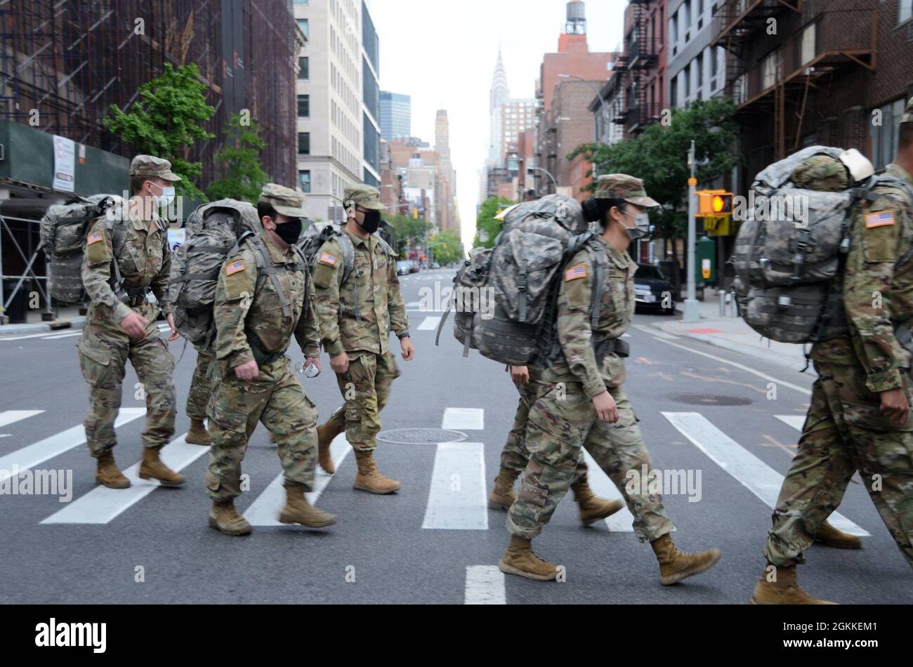 With the Chrysler building dominating the skyline, New York Army National Guard medics assigned to the Headquarters Company of the 1st Battalion, 69th Infantry Regiment conduct a six mile ruck march through Manhattan during the early morning hours on May 16, 2021. Thirty-six medics took part in the march as a train up for a required ruck march during annual training. U.S. A Stock Photo