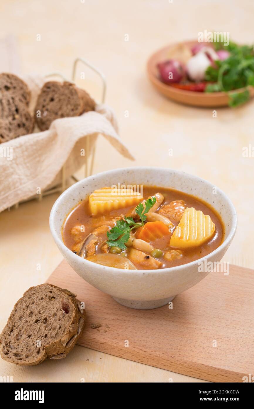Vegetarian curry from vegetables with coconut milk and black break close-up in a bowl on the table. Eat clean. Stock Photo