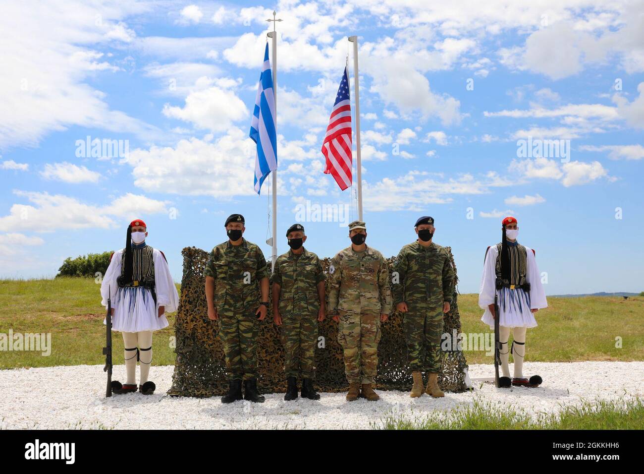 Alabama National Guard Lt. Col. John Craft, commander of the 1-167th  Infantry Battalion stands, in front of the American and Greek flags, with  officers from the Hellenic Army at the opening ceremony