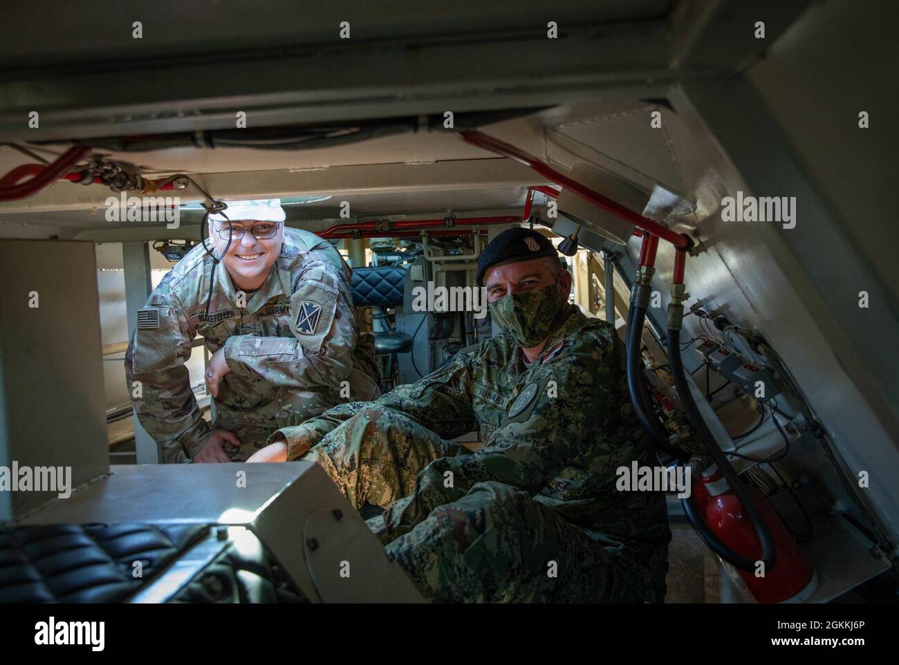U.S. Sgt. John Rockefeller, a Patriot fire control enhanced operator  maintainer assigned to 5th Battalion, 7th Air Defense Artillery, left, is  given a tour of Samohodni Raketni Sustav “S-10 CRO/A1” by Croatian