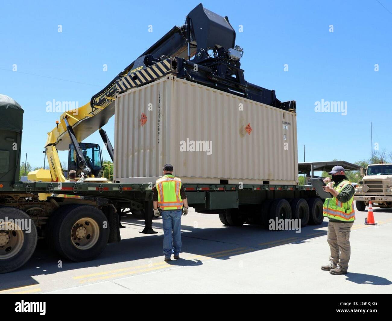 The Depot’s Lead Engineering Equipment Operator Johnny King (R) checks all the required paperwork is correct, including making sure the right munitions container is paired up with the right tractor-trailer rig before it moves on to the next out loading station. (SFC Rebecca E. Wood) Stock Photo