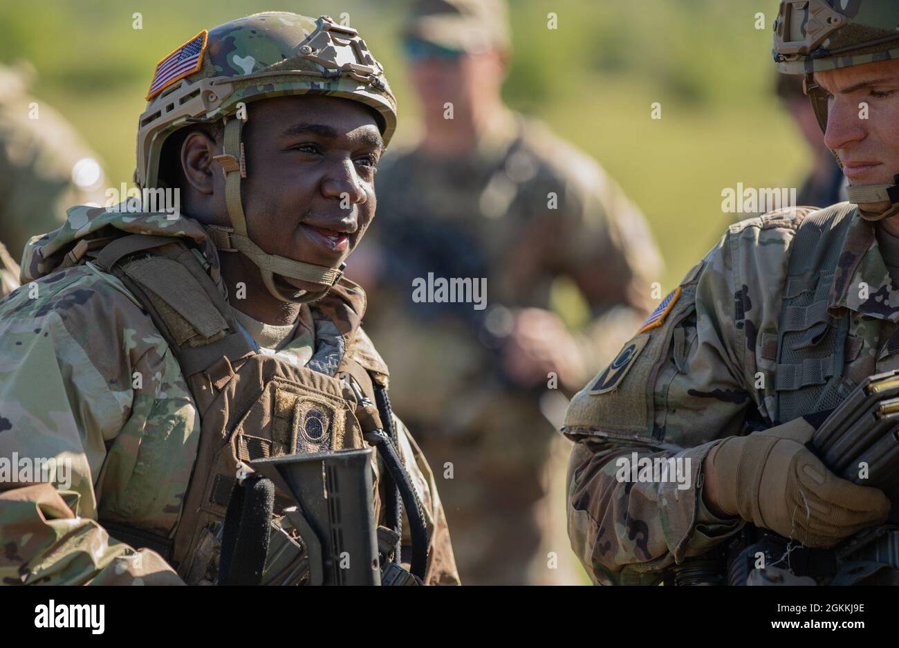 Spc. Odell August, an indirect fire infantryman assigned to 2nd Battalion, 124th Infantry Regiment, 53rd Infantry Brigade Combat Team, shares a laugh with his battle buddies before stepping onto a shooting range at Manjača Training Area, Bosnia and Herzegovina (BiH), May 18, 2021. The 2-124th Soldiers are participating in Immediate Response 21, a joint training exercise, alongside the Armed Forces of Bosnia and Herzegovina (AFBiH). Immediate Response is an exercise in support of DEFENDER-Europe 21. DEFENDER-Europe 21 is a prime example of U.S. forces working together closely with NATO allies a Stock Photo