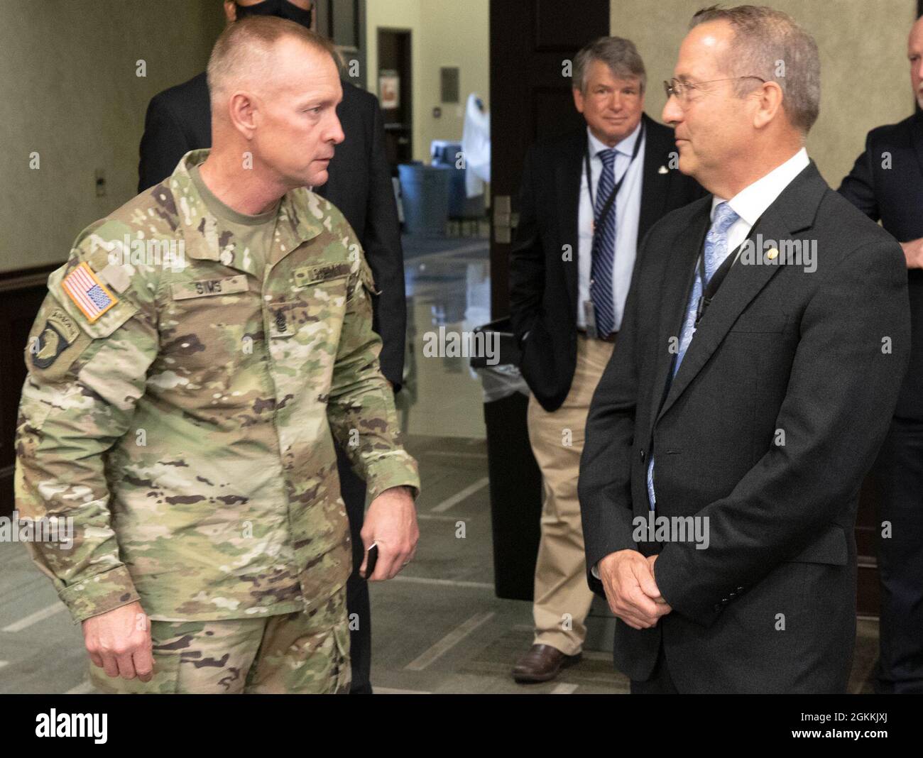 Command Sgt. Maj. Todd Sims talks with Roland Butler, a First