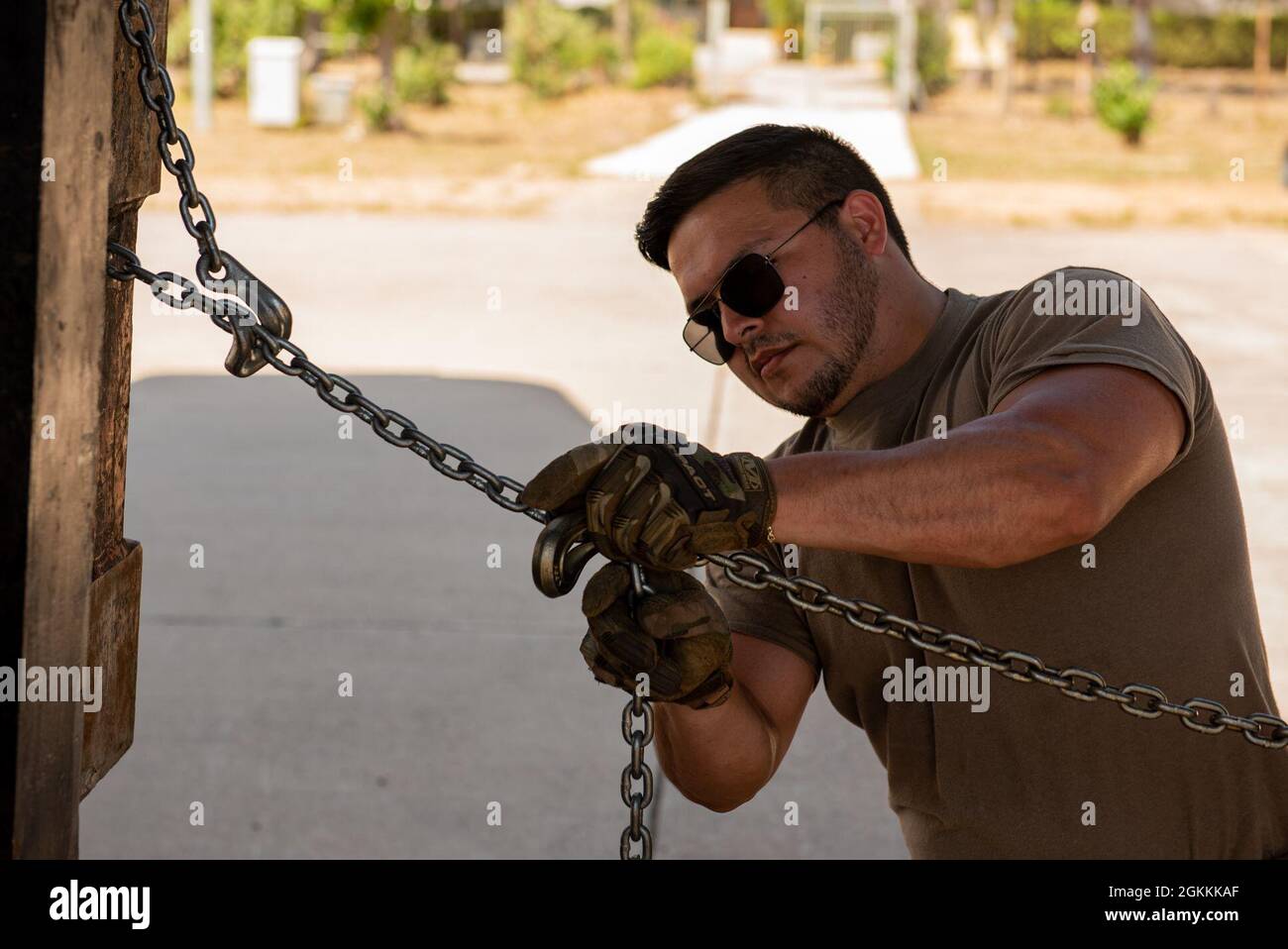 U.S. Air Force Staff Sgt. Zachary Coonrod, 86th Operational Support Squadron weather journeyman, uses a 10,000-pound chain to secure a cargo pallet during a combat offload training scenario as part of Operation Stolen Cerberus VIII at Elefsis Air Base, Greece, May 18, 2021. Coonrod supports the bilateral training event as a multi-capable Airmen (MCA) from the Cross-Functional Airlift Support Personnel (CASPER) program based at Ramstein Air Base, Germany. CASPER ensures any wing mission set can forward deploy or mobilize, as required, with minimal personnel and resources. Stock Photo