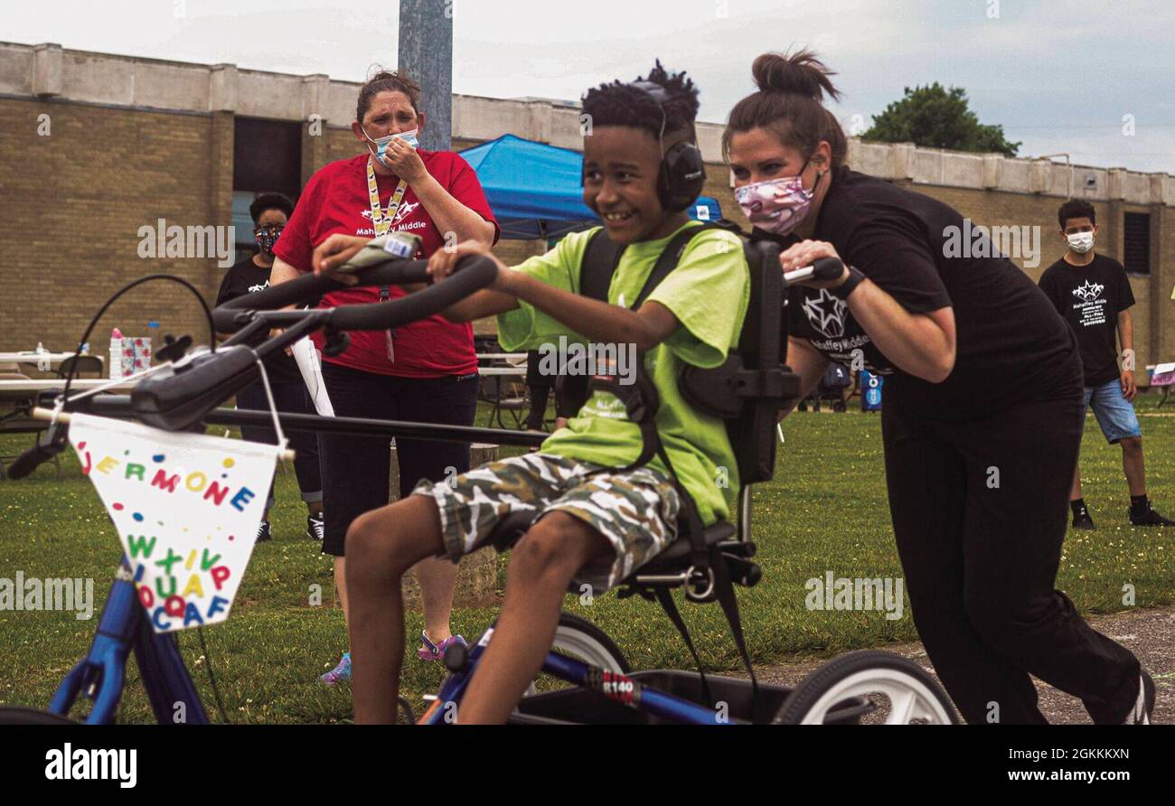 Carla Heckman, speech pathologist, pushes Jermone Norman, 11, May 18 while competing in the 50-yard dash during All-star Field Day at Mahaffey Middle School. Norman won a medal for crossing the finish line. Stock Photo