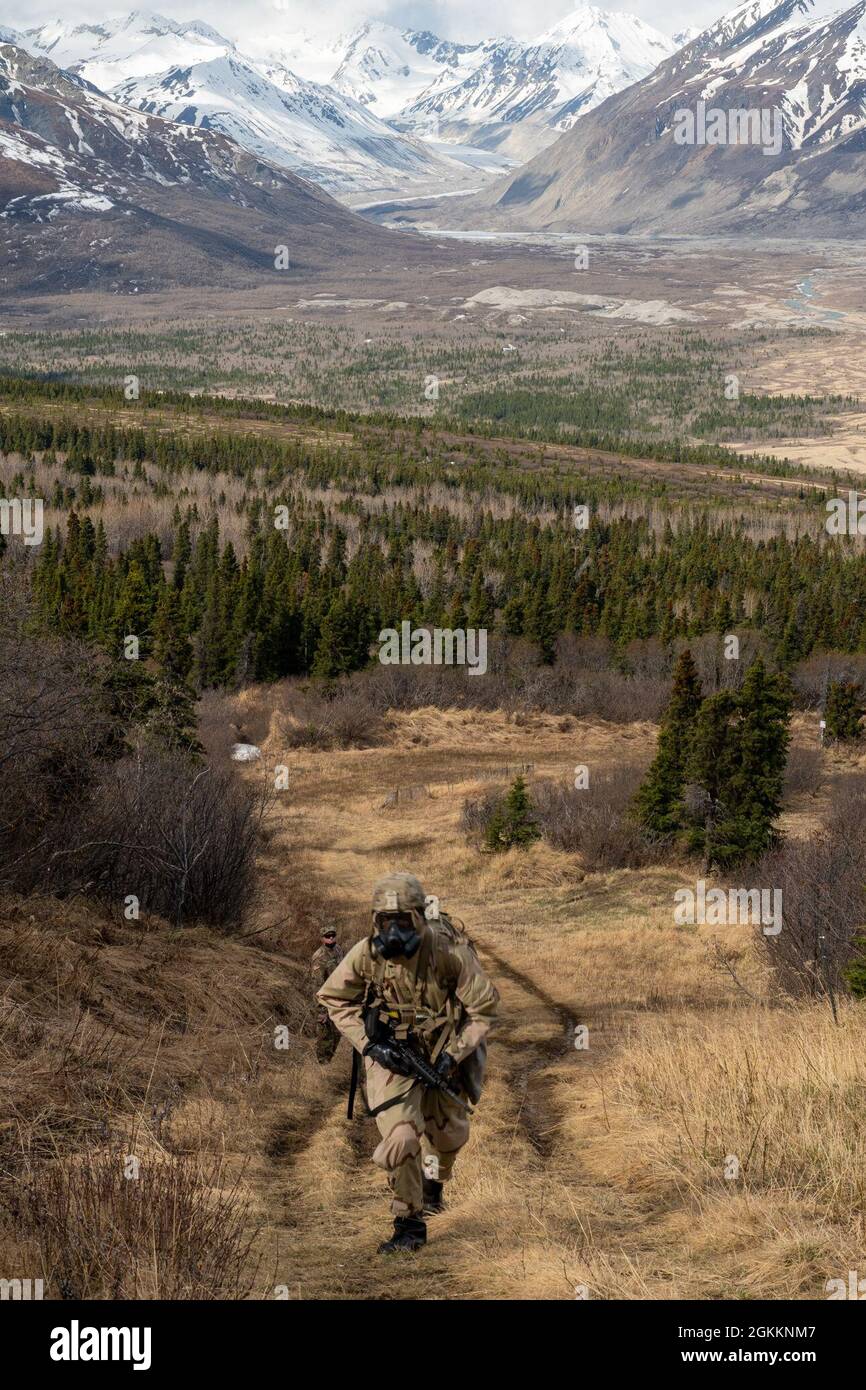 PVT Timothee Yappi, 17th Combat Sustainment Support Battalion, runs up the Chemical, Biological, Radiological and Nuclear Protection lane during the US Army Alaska Best Warrior Competition, May 19, 2021 at Northern Warfare Training Center, Black Rapids Training Site. Stock Photo
