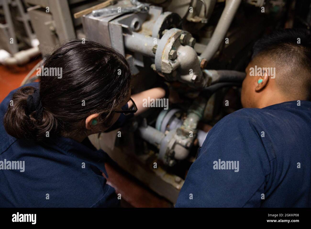 210519-N-CJ510-0244 ATLANTIC OCEAN (May 19, 2021) Gas Turbine Systems Technician (Mechanical) Fireman Arizbeth Cardenas, left, and Gas Turbine Systems Technician (Mechanical) 3rd Class Reynante Imperial conduct maintenance on a low pressure air compressor in a main space aboard the Arleigh Burke-class guided-missile destroyer USS Roosevelt (DDG 80), May 19, 2021. Roosevelt is participating in At-Sea Demo/Formidable Shield, conducted by Naval Striking and Support Forces NATO on behalf of U.S. Sixth Fleet, is a live-fire integrated air and missile defense (IAMD) exercise that improves Allied int Stock Photo
