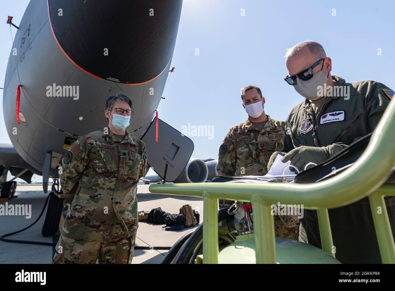 U.S. Air Force Maj. Stephen Ayres, right, Capt. Robert Hutchinson, and Lt. Col. Rebecca Gibbs, all with the 141st Air Refueling Squadron, go over pre-flight paperwork before a training mission in a KC-135R Stratotanker on Joint Base McGuire-Dix-Lakehurst, N.J., May 19, 2021. Stock Photo