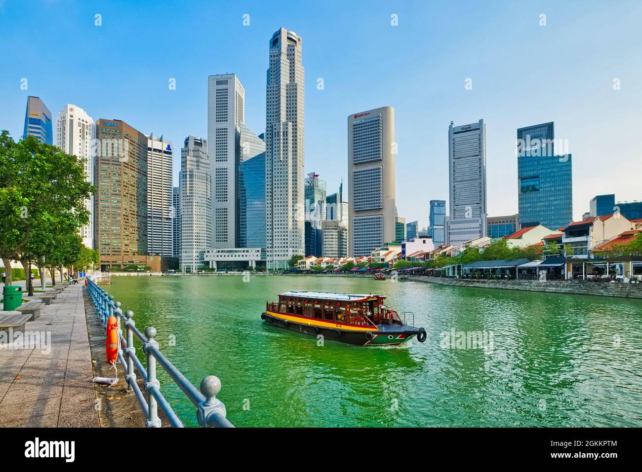 A tour boats cruising on the Singapore River past Boat Quay (r), in the
