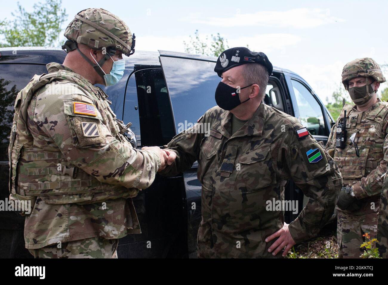 U.S. Army Lt. Gen. Roger L. Cloutier Jr. , commander of the Allied Land Command, left, shakes hands with Polish Army Inspector of the Land Forces, Maj. Gen. Maciej Jablonski, May 20, 2021, Artillery and Armament Training Center, during the Dynamic Front 21 training exercise in Torun, Poland. Dynamic Front 21 is a 7th Army Training Command-led, U.S. Army Europe and Africa-directed exercise designed to increase readiness, lethality and interoperability by exercising allied an d partner nations' ability to integrate joint fires in a multinational environment at both the operational and tactical l Stock Photo
