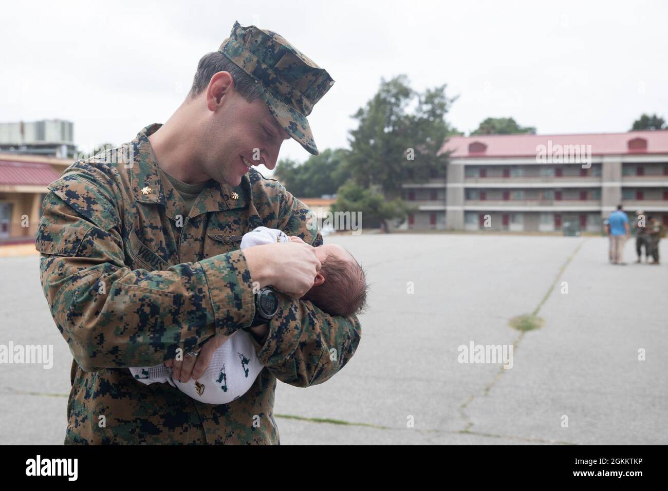 U.S. Marine Corps Maj. Scott Vigus, F/A-18 Super Hornet weapons systems  officer with Battalion Landing Team, 1st Battalion, 4th Marine Regiment,  attached to the 15th Marine Expeditionary Unit holds his newborn son