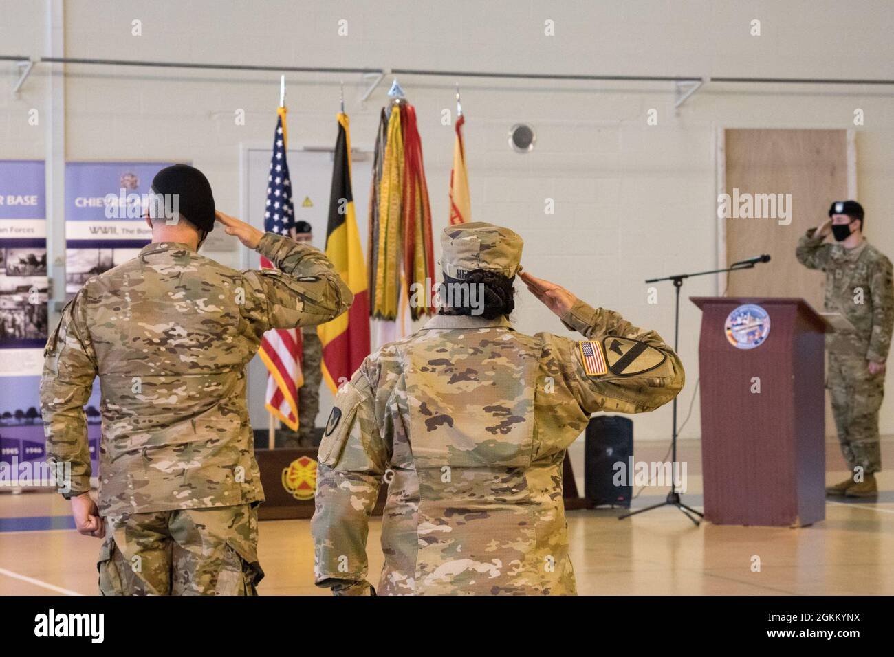 U.S. Army Garrison Benelux Commander, Col. James Yastrzemsky and Senior  Enlisted Adviser, Command Sgt. Maj. Katrina Herzfeld pay respect to the  flags during the Headquarters and Headquarters Company Relinquishment of  Command ceremony,