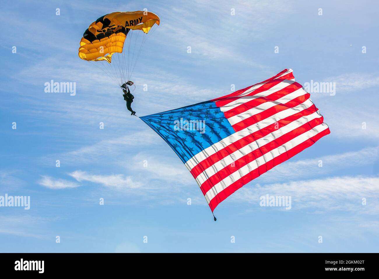 Staff Sgt. Dominic Perry makes a jump with the American flag banner over Laurinburg-Maxton Airport. Stock Photo