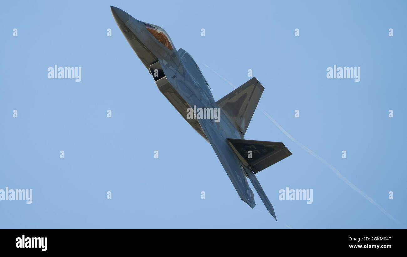 U.S. Air Force Maj. Josh Gunderson, F-22 Demo Team commander, conducts a practice show over Joint Base Langley-Eustis, Virginia, May 21, 2021.  The team flies at airshows around the globe performing maneuvers that demonstrate the capabilities of the fifth-generation fighter aircraft. Stock Photo