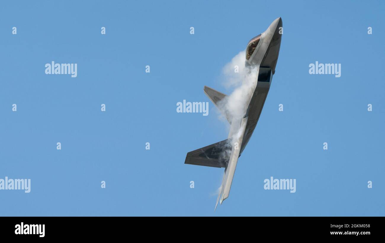 U.S. Air Force Maj. Josh Gunderson, F-22 Demo Team commander, conducts a practice show over Joint Base Langley-Eustis, Virginia, May 21, 2021.  The team flies at airshows around the globe performing maneuvers that demonstrate the capabilities of the fifth-generation fighter aircraft. Stock Photo