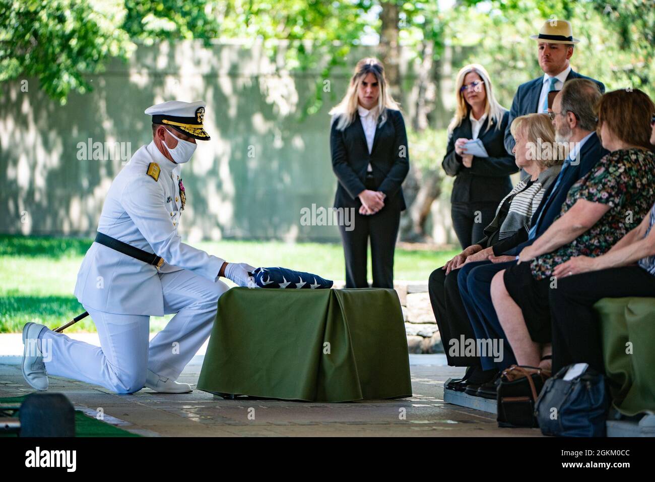 The U.S. flag is presented to Betty Joe Griffith Price at the conclusion of the funeral service for her brother, U.S. Navy Radioman 3rd Class Thomas Griffith, in Section 60 of Arlington National Cemetery, Arlington, Virginia, May 21, 2021.     Griffith was assigned to the battleship USS Oklahoma, which was moored at Ford Island, Pearl Harbor when it was attacked by Japanese aircraft on Dec. 7, 1941 during World War II. The USS Oklahoma sustained multiple torpedo hits, which caused it to quickly capsize. The attack on the ship resulted in the deaths of 429 crewmen, including Griffith, who was 2 Stock Photo