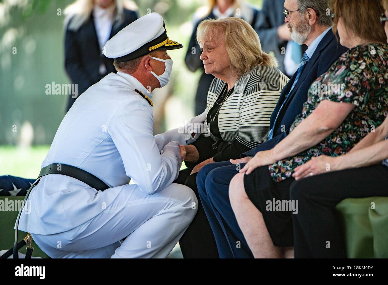 Condolences are offered to Betty Joe Griffith Price at the conclusion of the funeral service for her brother, U.S. Navy Radioman 3rd Class Thomas Griffith, in Section 60 of Arlington National Cemetery, Arlington, Virginia, May 21, 2021.     Griffith was assigned to the battleship USS Oklahoma, which was moored at Ford Island, Pearl Harbor when it was attacked by Japanese aircraft on Dec. 7, 1941 during World War II. The USS Oklahoma sustained multiple torpedo hits, which caused it to quickly capsize. The attack on the ship resulted in the deaths of 429 crewmen, including Griffith, who was 20 y Stock Photo