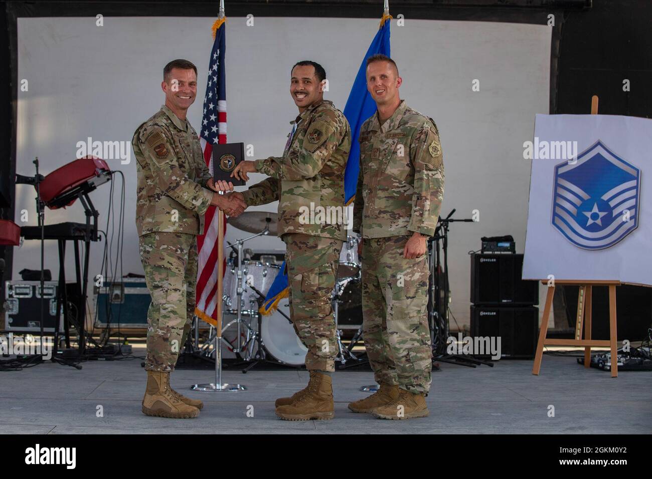 U.S. Air Force Brig. Gen. Larry R. Broadwell, 380th Air Expeditionary Wing commander (AEW), and Chief Master Sgt. Joshua J. Wiener, 380th AEW command chief, pose with Tech. Sgt. Kurits Chase, 380th Expeditionary Logistics Readiness Squadron, at Al Dhafra Air Base (ADAB), United Arab Emirates, May 21, 2021. Chase is one of 19 team ADAB technical sergeants that were selected for promoted to master sergeant this year. Stock Photo
