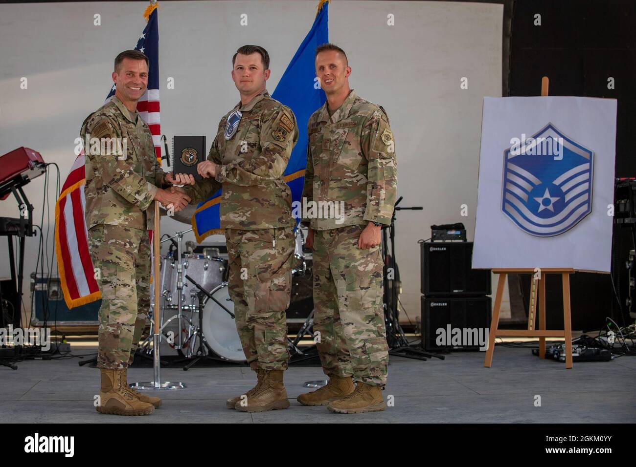 U.S. Air Force Brig. Gen. Larry R. Broadwell, 380th Air Expeditionary Wing commander (AEW), and Chief Master Sgt. Joshua J. Wiener, 380th AEW command chief, pose with Tech. Sgt. Kenneth Dunn, 380th Expeditionary Civil Engineer Squadron, at Al Dhafra Air Base (ADAB), United Arab Emirates, May 21, 2021. Dunn is one of 19 team ADAB technical sergeants that were selected for promoted to master sergeant this year. Stock Photo