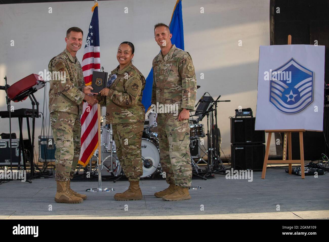 U.S. Air Force Brig. Gen. Larry R. Broadwell, 380th Air Expeditionary Wing commander (AEW), and Chief Master Sgt. Joshua J. Wiener, 380th AEW command chief, pose with Tech. Sgt. Destiney Villalpando, 380th Expeditionary Force Support Squadron, at Al Dhafra Air Base (ADAB), United Arab Emirates, May 21, 2021. Villalpando is one of 19 team ADAB technical sergeants that were selected for promoted to master sergeant this year. Stock Photo