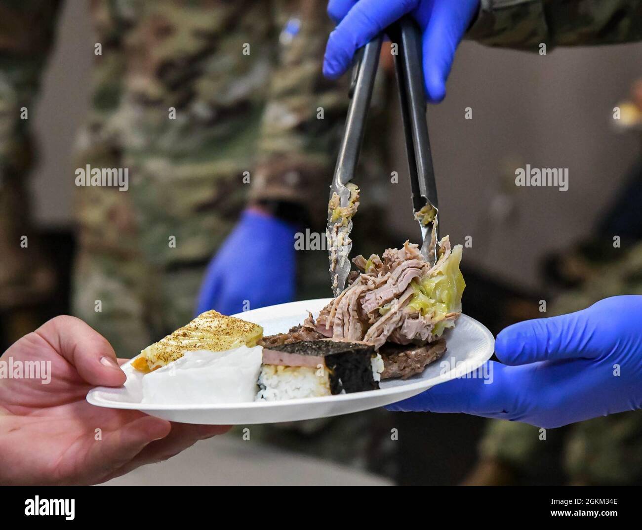 Hawaiian Kalua pork is served during the Asian American and Pacific Islander Heritage Month Expo at Dover Air Force Base, Delaware, May 21, 2021. Kalua pork is traditionally cooked in an Imu, an underground oven, with tropical leaves placed on top to steam cook the pork. Stock Photo