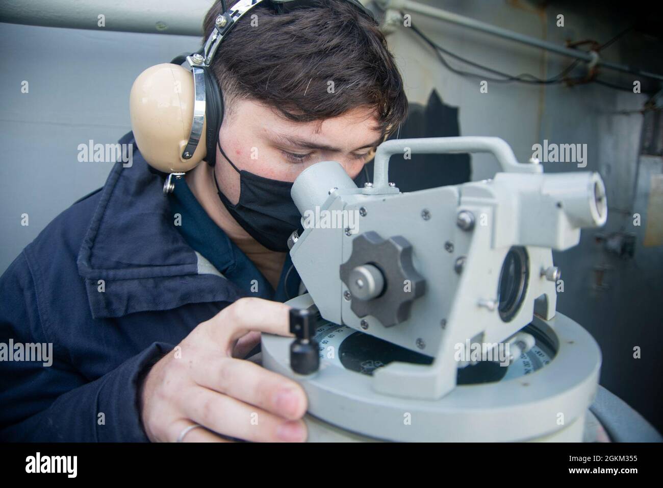 210521-N-ZE328-1020 NORFOLK, Va. (May 21, 2021) Quartermaster 3rd Class Jacob Renfrow, from Owensboro, Kentucky, uses a telescopic alidade on the signal bridge of the Nimitz-class aircraft carrier USS Harry S. Truman (CVN 75) during sea trials after completing an extended carrier incremental availability. Sea trials include a comprehensive test of the ship’s systems and technologies in order to ensure the ship is ready to resume operations. Stock Photo