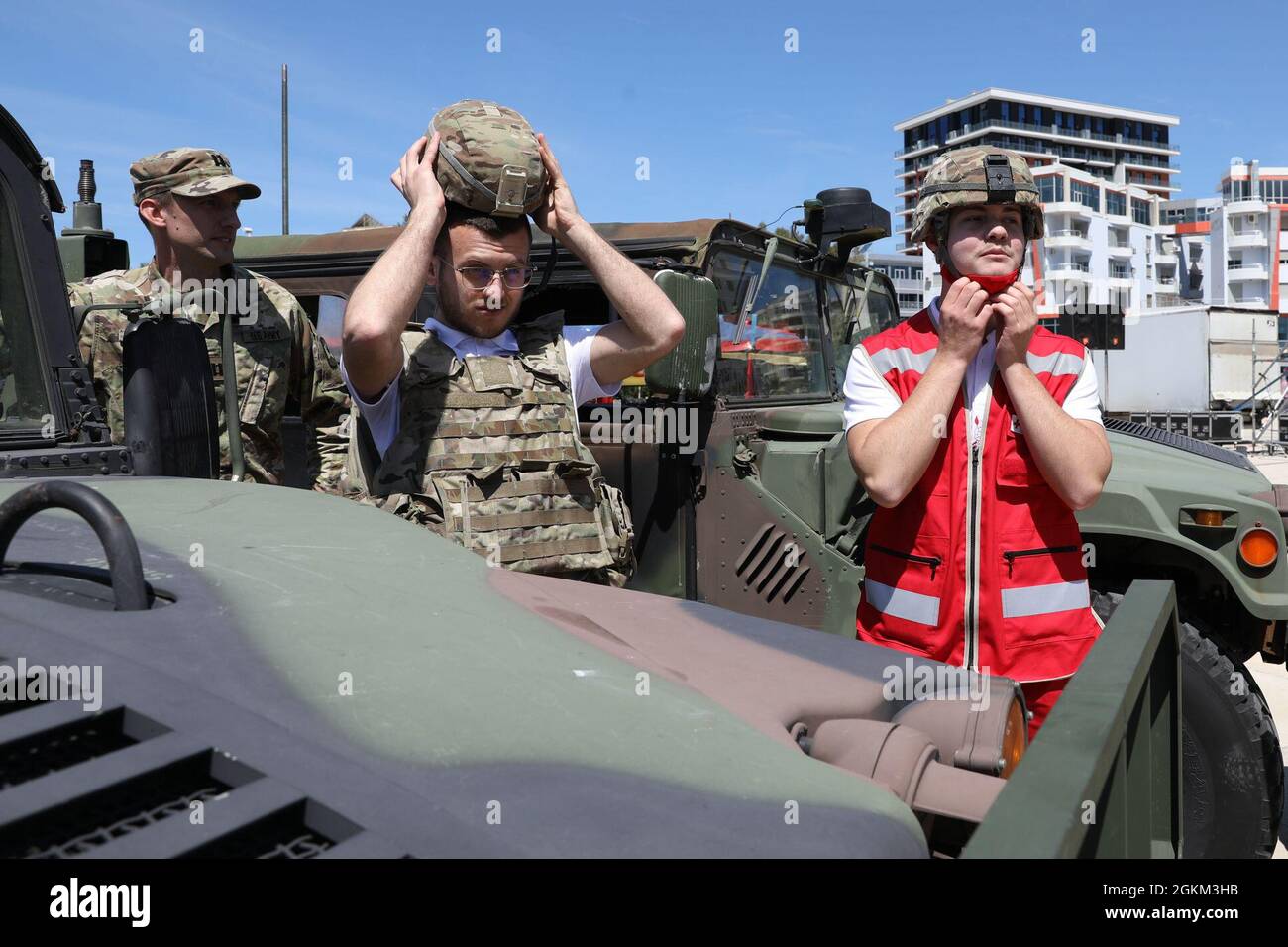 Volunteers from the Albanian Red Cross booth in Vlore have a little fun  trying on U.S. military equipment with U.S. Army Able Company, 457th Civil  Affairs Battalion, Civil Affairs Team members at