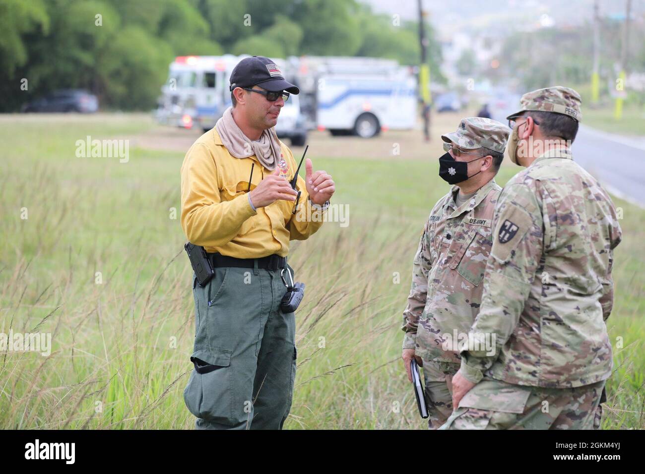 Fire Lt. Joel Figueroa, left, discusses the operations with Lt. Col. Rodolfo Colón and Col. Víctor Pérez at Gurabo, Puerto Rico, May 22, 2021. The Governor of Puerto Rico, Pedro Pierluisi, activated the National Guard in support of the Puerto Rico Fire Department to fight fires in the municipalities of Gurabo and Cayey to protect residents' health, well-being, and property. Stock Photo