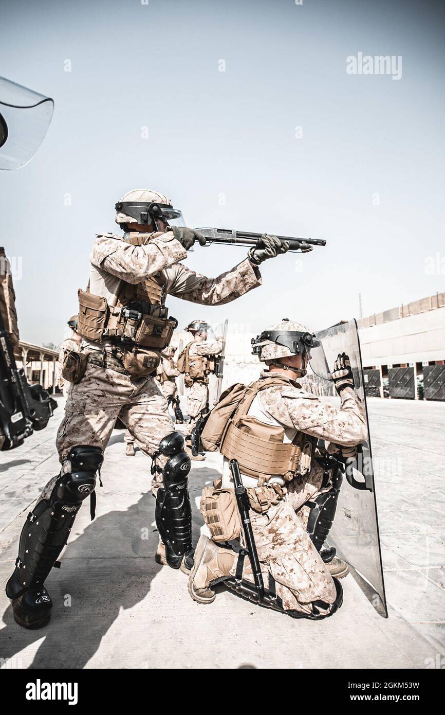 U.S. Marines with 2nd Battalion, 1st Marines, assigned to the Special Purpose Marine Air-Ground Task Force – Crisis Response – Central Command (SPMAGTF-CR-CC) engage in riot control training during a non-lethal weapons training exercise, May 22, 2021. The training provided the Marines with tools to de-escalate a hostile situation without using lethal force. The SPMAGTF-CR-CC is a multiple force provider designed to employ ground, logistics and air capabilities throughout the Central Command area of responsibility. Stock Photo