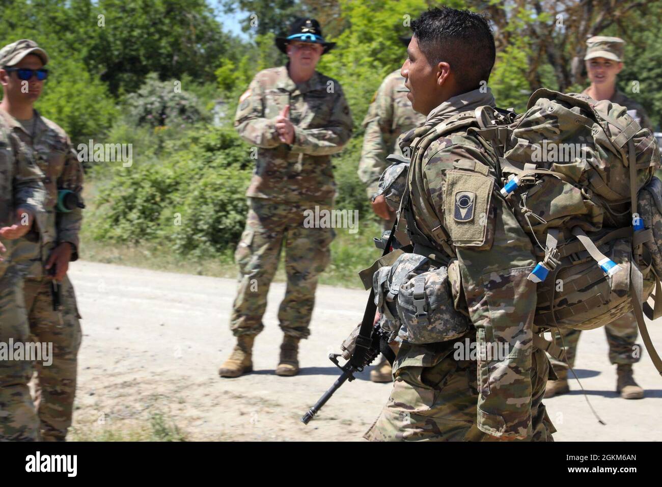 U.S. Army Florida National Guard, 1st Squadron, 153rd Cavalry Regiment Soldiers congratulate candidates after completing the 10 mile ruck march during the Spur Ride, a two day training event with a series of physical and mental tests that evaluate the Soldiers skills, at Krivolak Training area, North Macedonia, May 23, 2021. All Soldiers shown are fully vaccinated and tested negative for COVID-19. DEFENDER-Europe 21 is a large-scale U.S. Army-led exercise designed to build readiness and interoperability between the U.S., NATO allies and partner militaries. This year, more than 28,000 multinati Stock Photo