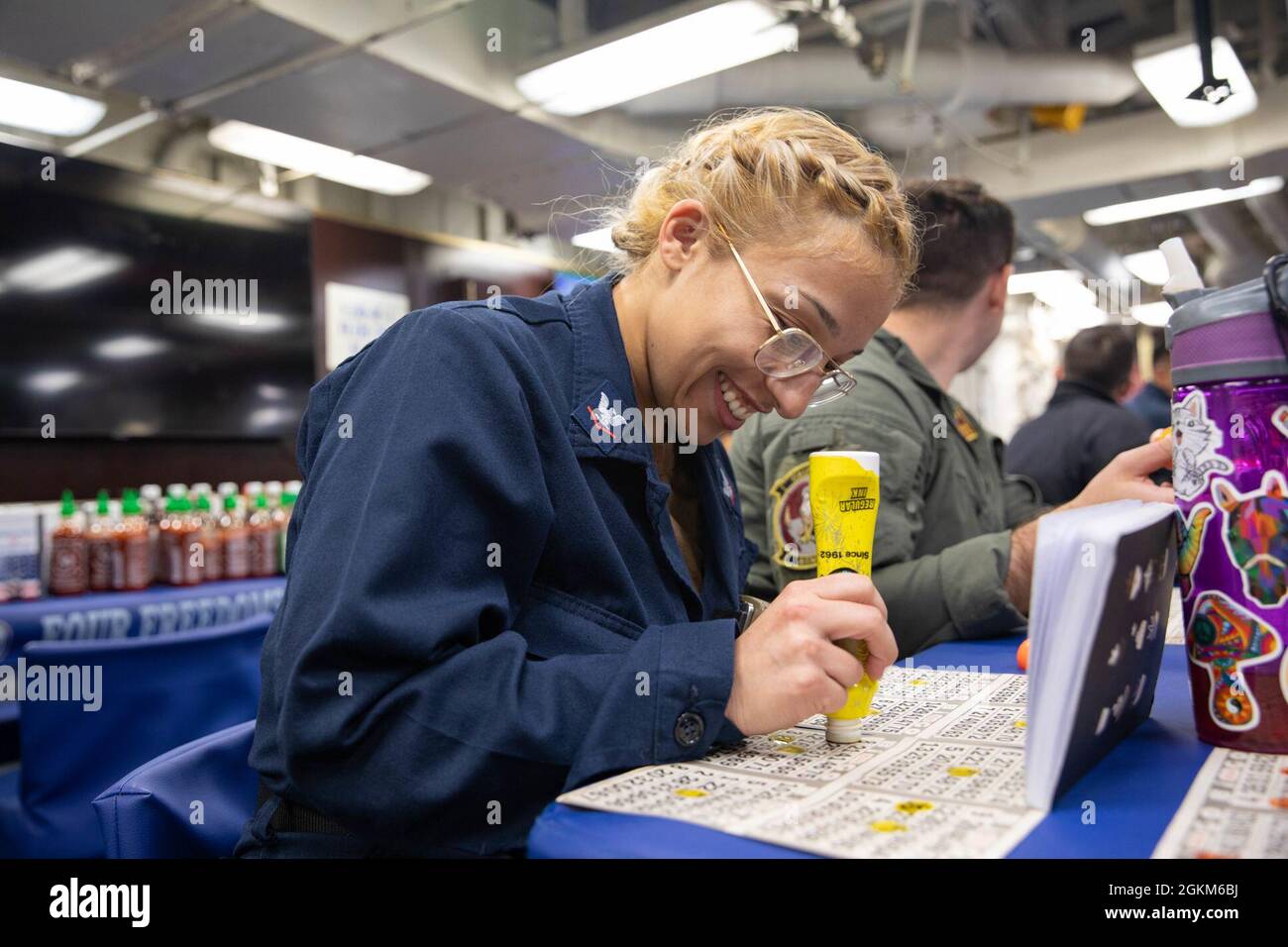 ATLANTIC OCEAN (May 23, 2021) Electronics Technician 3rd Class Jessica Quinn marks a bingo card on the mess decks of the Arleigh Burke-class guided-missile destroyer USS Roosevelt (DDG 80), May 23, 2021.  Roosevelt is participating in At-Sea Demo/Formidable Shield, conducted by Naval Striking and Support Forces NATO on behalf of U.S. Sixth Fleet, is a live-fire integrated air and missile defense (IAMD) exercise that improves Allied interoperability using NATO command and control reporting structures. Stock Photo