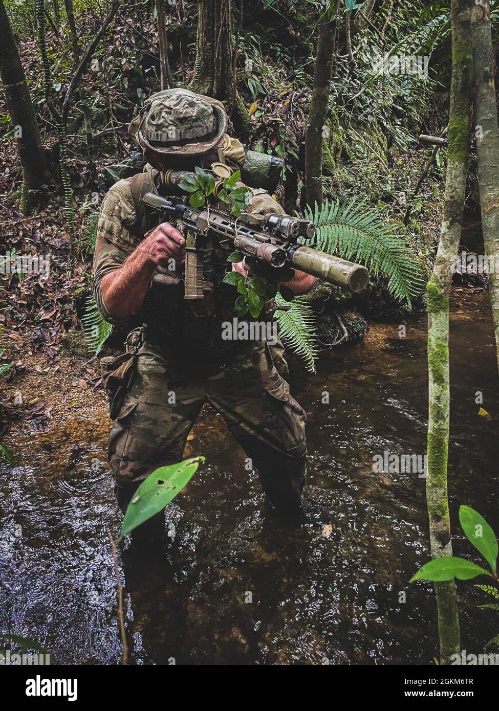 OKINAWA, Japan. — A Green Beret with 1st Battalion, 1st Special Forces  Group (Airborne) moves through ankle high water during the 4th Marine  Regiment Jungle Warfare Exercise at the Jungle Warfare Training