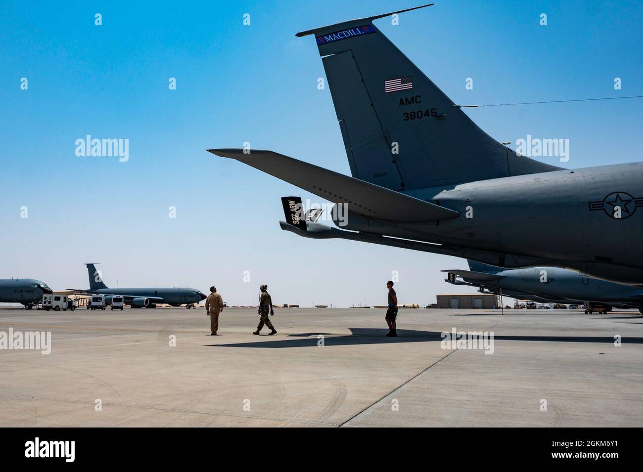 A U.S. Air Force KC-135R Stratotanker aircraft pilot assigned to the 340th Expeditionary Air Refueling Squadron and maintainers from 379th Expeditionary Maintenance Group inspect an aircraft prior to an operation supporting the Resolute Support Mission in Afghanistan at Al Udeid Air Base, Qatar, May 23, 2021. The KC-135R delivers U.S. Air Forces Central a global reach through its aerial refueling capability that supports joint and partner nation aircraft throughout the area of responsibility. Stock Photo