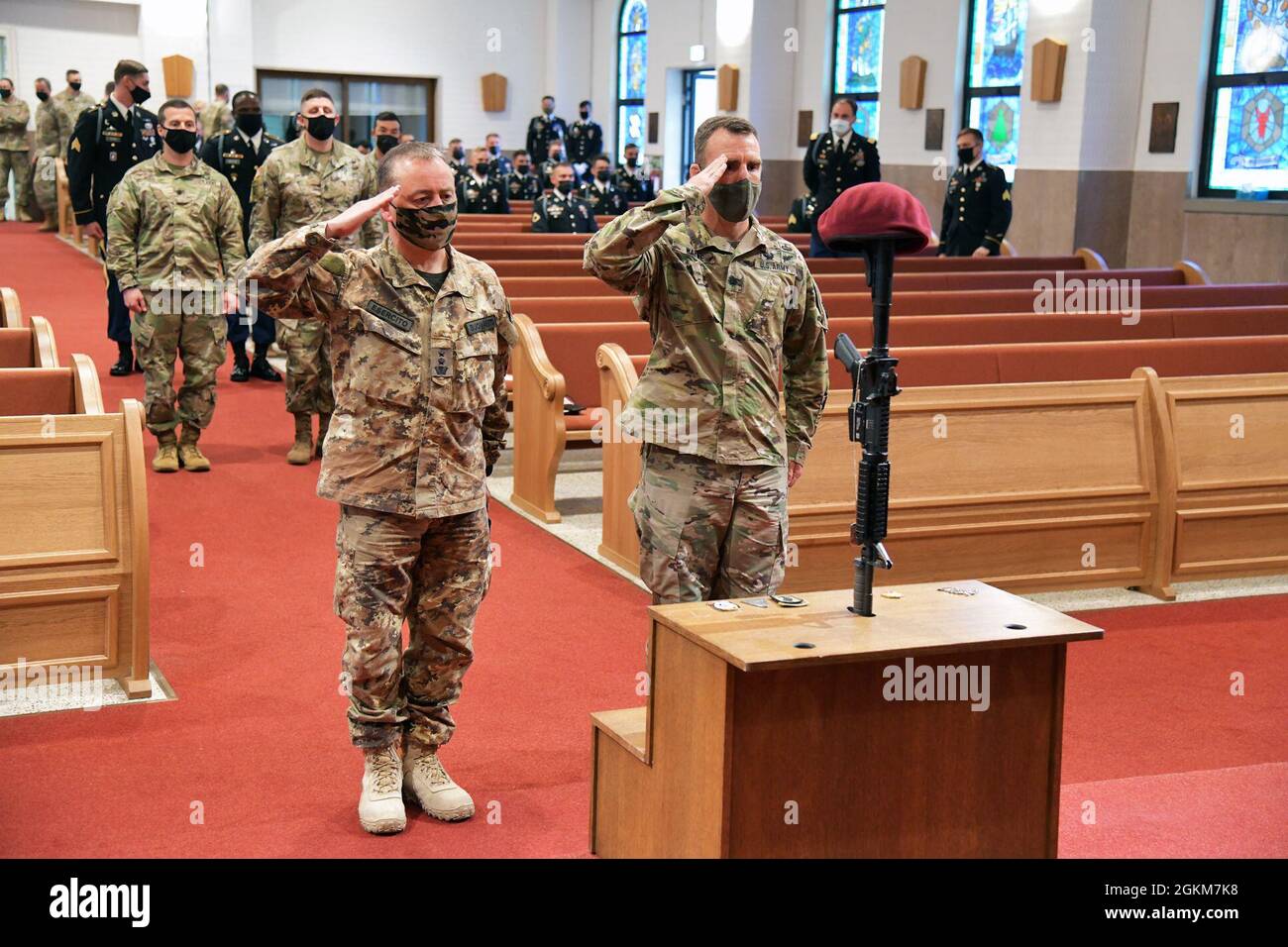 Italian Army Lt. Col. Giorgio Buonaiuto, left, and Lt. Col. Jason R. Wayne Deputy Commander of the 173rd Airborne Brigade, right, salute Pfc. Ian N. Morosoff, who died May 1 from injuries sustained in a car accident, Caserma Ederle, Vicenza, Italy, May 24, 2021. Stock Photo
