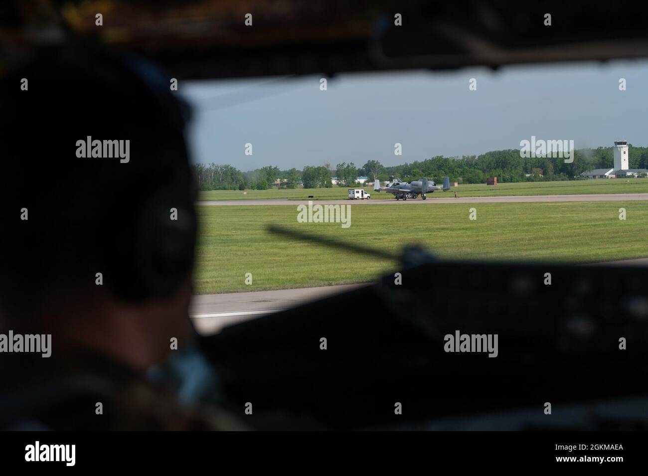 U.S. Air Force Capt. Nathan Foltz, an instructor pilot assigned to the 50th Air Refueling Squadron, looks on as U.S. Air Force A-10 Thunderbolt II’s assigned to the Michigan Air National Guard taxi at Selfridge ANG Base, Michigan, May 25, 2021. Mobility Guardian embodies the Total Force Mobility Airmen mindset to project strength and deliver hope, by exercising airlift, air refueling, aeromedical evacuation and global air mobility support. Stock Photo