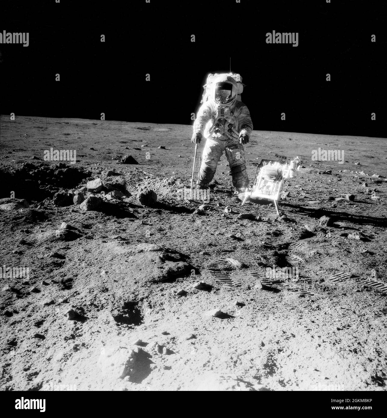 (19-20 Nov. 1969) --- One of the Apollo 12 crew members is photographed with the tools and carrier of the Apollo Lunar Hand Tools (ALHT) during extravehicular activity (EVA) on the surface of the moon. Several footprints made by the two crew members during their EVA are seen in the foreground. While astronauts Charles Conrad Jr., commander, and Alan L. Bean, lunar module pilot, descended in the Lunar Module (LM) 'Intrepid' to explore the Ocean of Storms region of the moon, astronaut Richard F. Gordon Jr., command module pilot, remained with the Command and Service Modules (CSM) 'Yankee Clipper Stock Photo