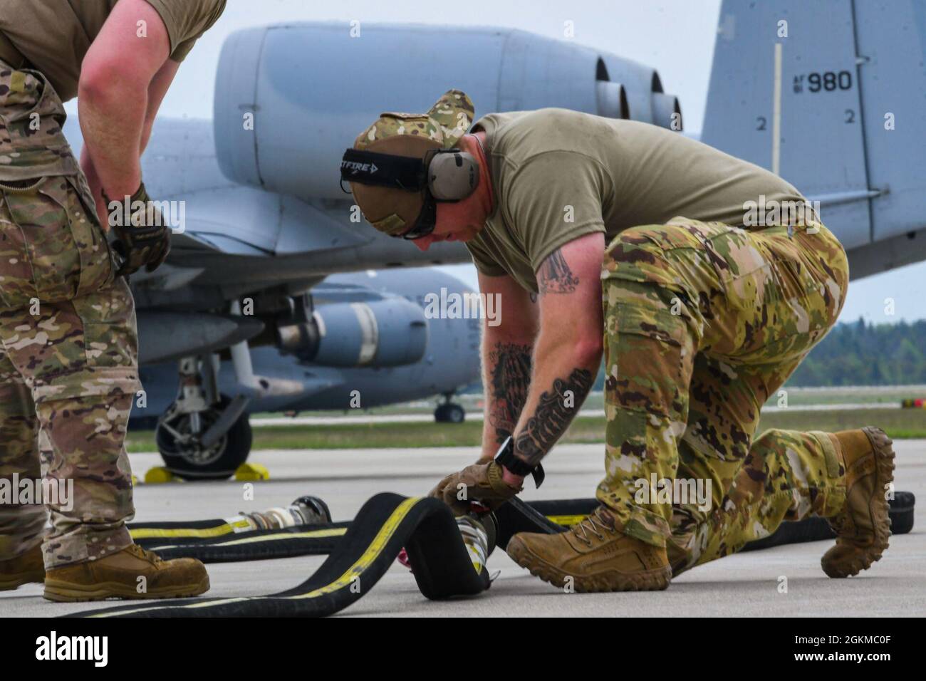 An Airmen from the 19th Airlift Wing prepares a hose for refueling at Alpena Combat Readiness Training Center, Michigan, May 25, 2021. The 354th Fighter Squadron worked alongside the 61st and 41st Airlift Squadrons in order to perform integrated combat turns, a rapid turnaround process that allowed U.S. Air Force A-10 Thunderbolt IIs to quickly rearm and refuel during Mobility Guardian 2021. Stock Photo