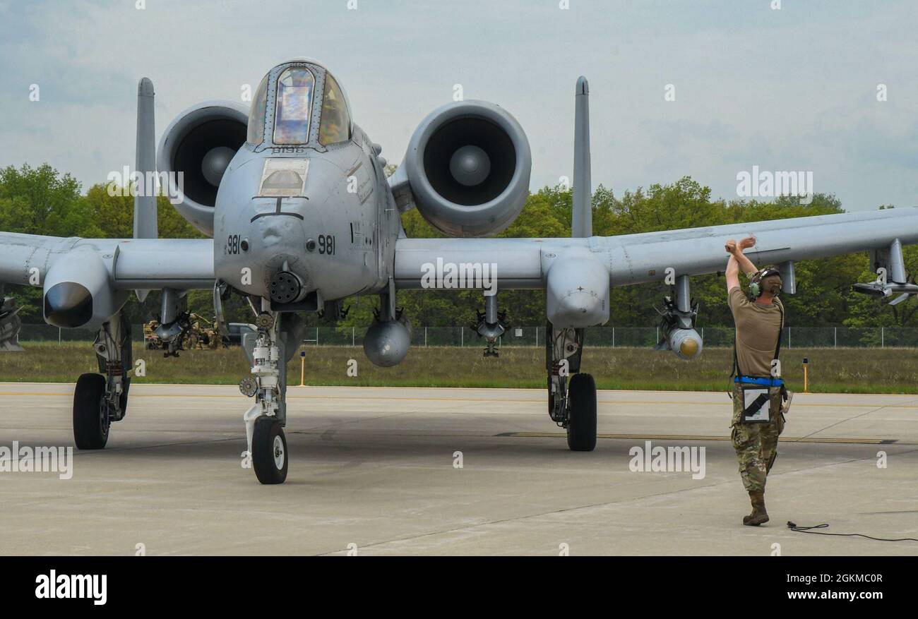 An Airman from the 354th Fighter Squadron signals a U.S. Air Force A-10 ...