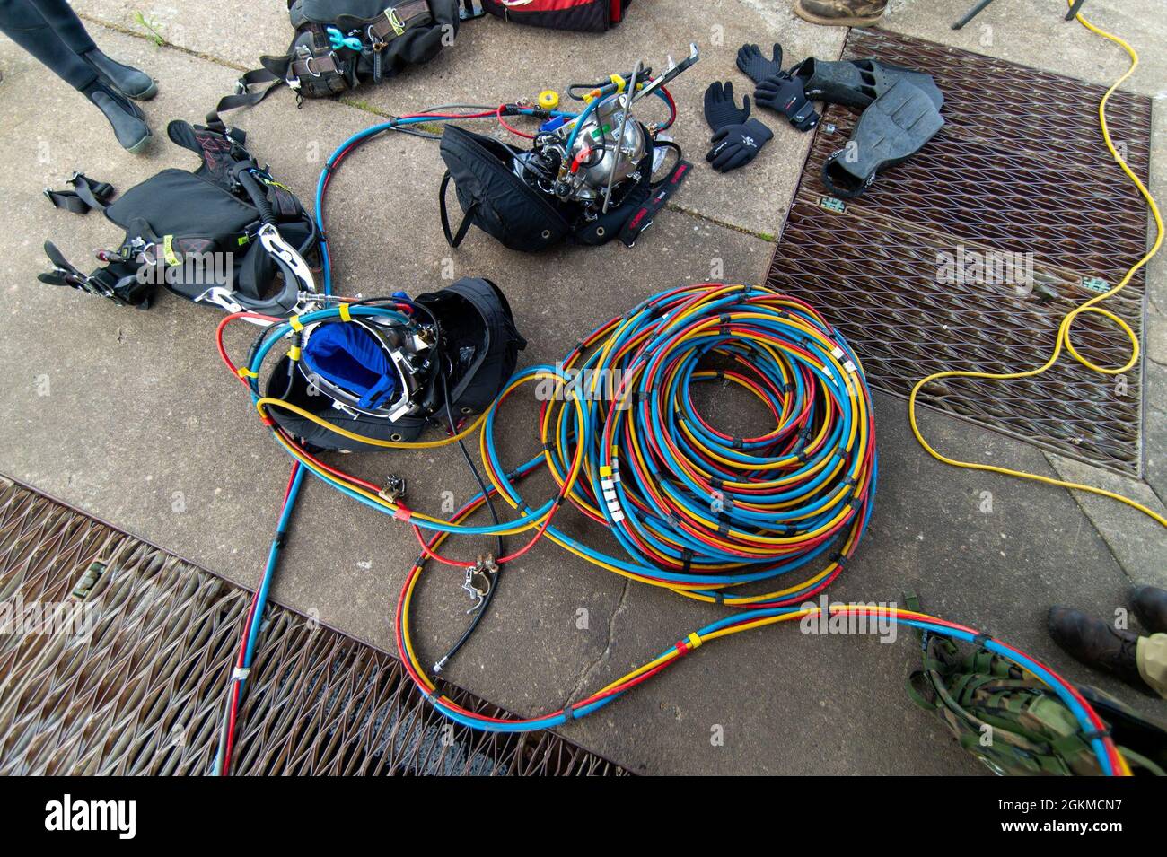 Diver suit equipment and umbilical cable is laid on the ground before a
