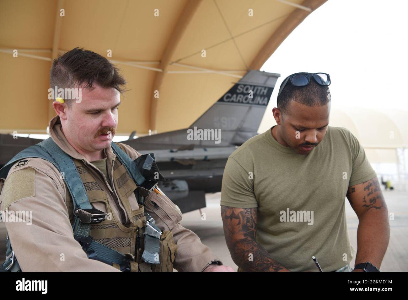 U S Air Force Staff Sgt Isaiah Johnson 157th Expeditionary Fighter Generation Squadron Avionics Technician Receives Aircraft Flight Data From U S Air Force Maj Evan Barger 157th Expeditionary Fighter Squadron Pilot Following A